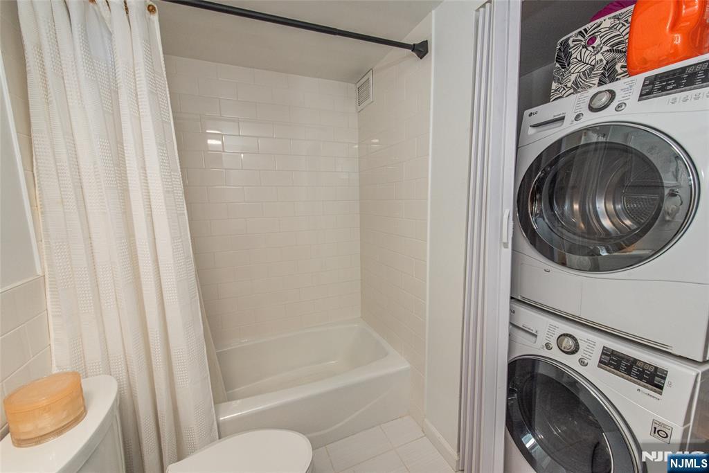 300 Main Street, Unit 211 Little Falls, NJ 07424 - Photo 15 of 30 a view of a bathroom with washing machine and a shower