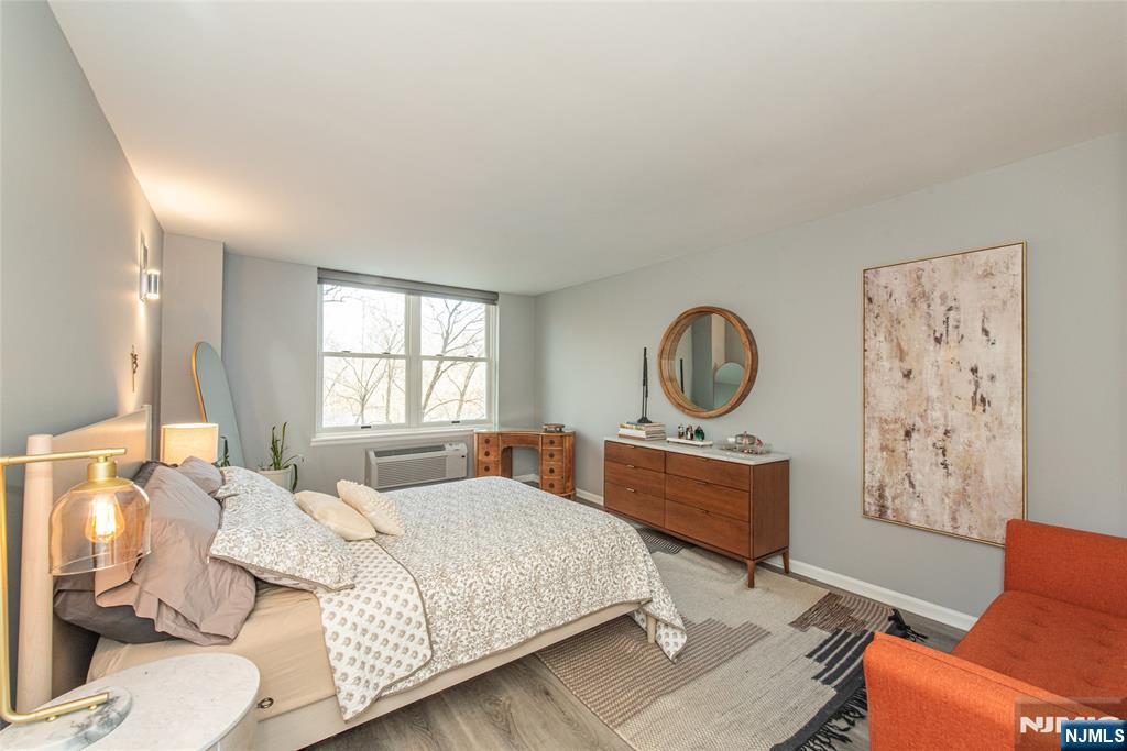 300 Main Street, Unit 211 Little Falls, NJ 07424 - Photo 16 of 30 a bedroom with a bed dresser and a window