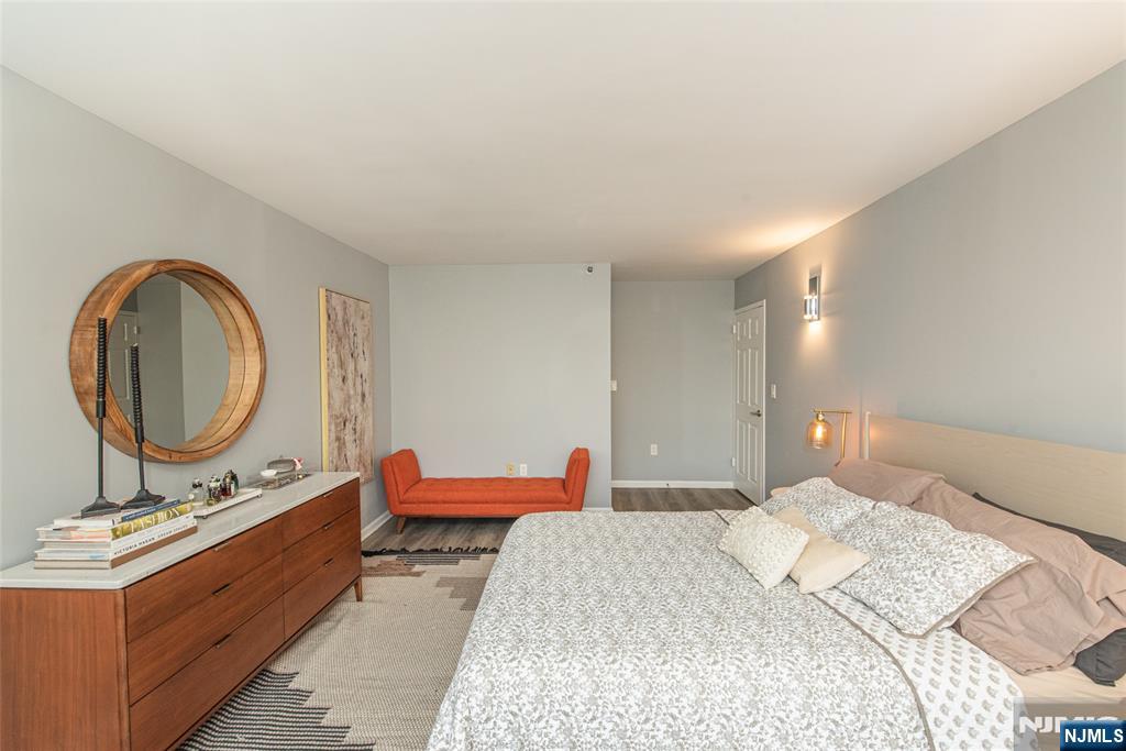 300 Main Street, Unit 211 Little Falls, NJ 07424 - Photo 18 of 30 a bed room with a bed and a mirror