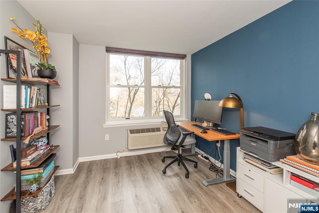 300 Main Street, Unit 211 Little Falls, NJ 07424 - Photo 22 of 30 a workspace with furniture and a book shelf