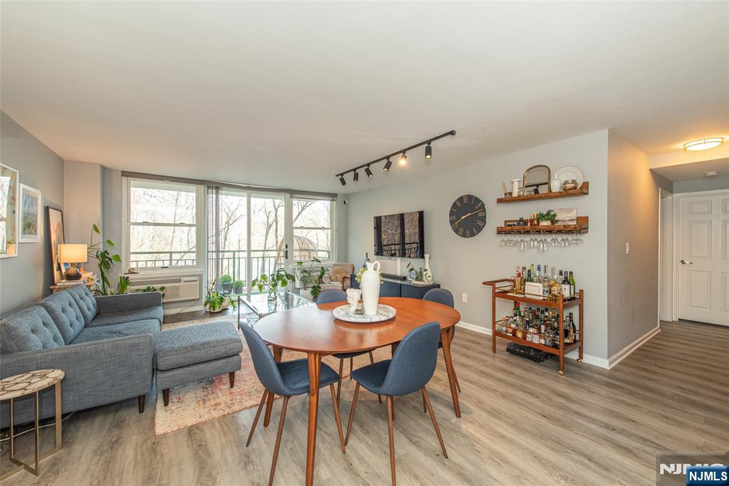 300 Main Street, Unit 211 Little Falls, NJ 07424 - Photo 5 of 30 a dining room with furniture and wooden floor