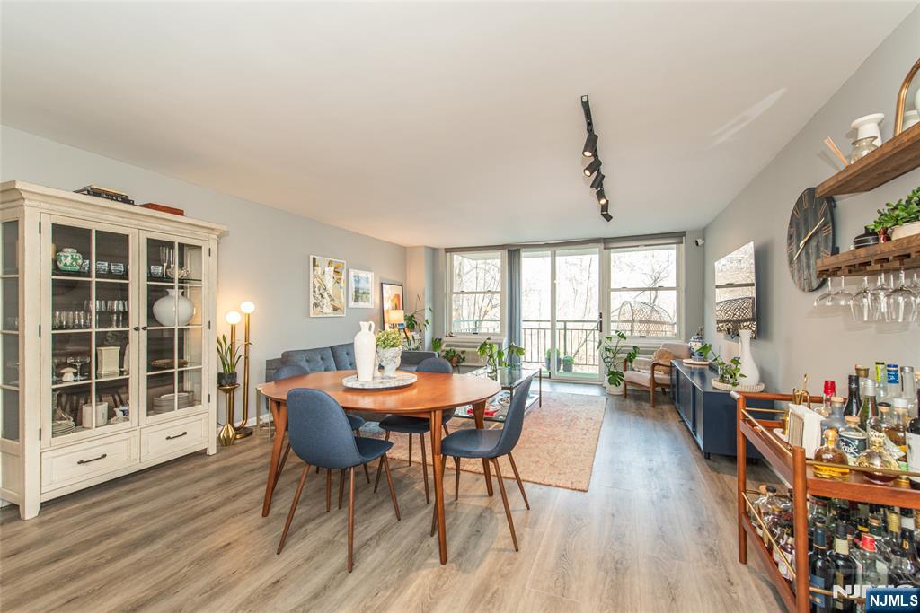 300 Main Street, Unit 211 Little Falls, NJ 07424 - Photo 6 of 30 a view of a dining room with furniture window and wooden floor