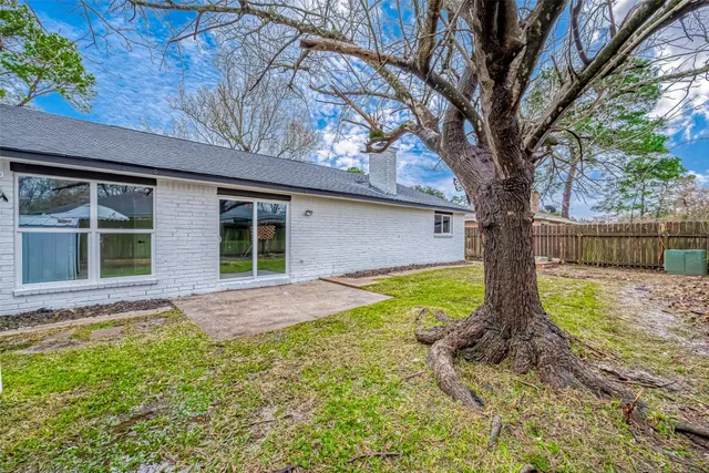 a view of house with backyard