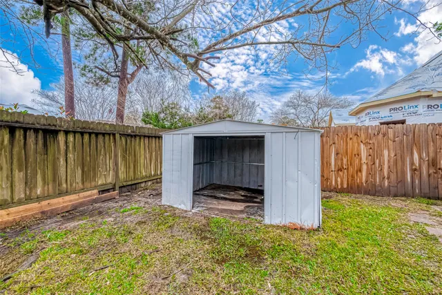 a view of a backyard with a tree