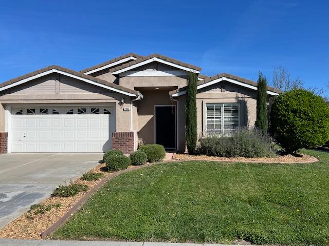 2005 Floral Court Modesto, CA 95356 - Photo 1 of 1 a front view of a house with a yard