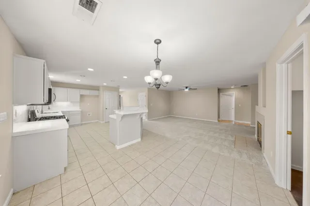 a view of a big room with closet and windows