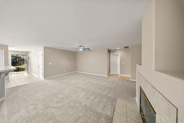 a view of a kitchen with a sink and a ceiling fan