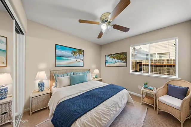 an empty room with a chandelier fan and windows