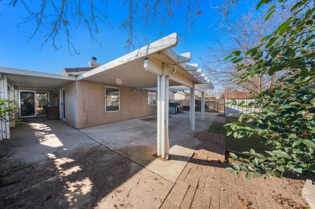 a view of a house with a wooden fence