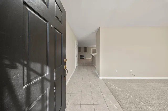 a view of a livingroom with a ceiling fan and window