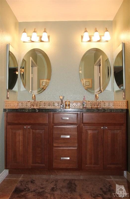 3970 Cochran Street, Unit 83 Simi Valley, CA 93063 - Photo 8 of 12 a bathroom with a granite countertop sink mirror and vanity