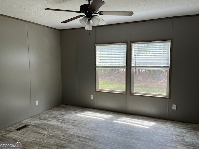 26 Ebenezer Church Road Swainsboro, GA 30401 - Photo 5 of 11 an empty room with a window and a ceiling fan