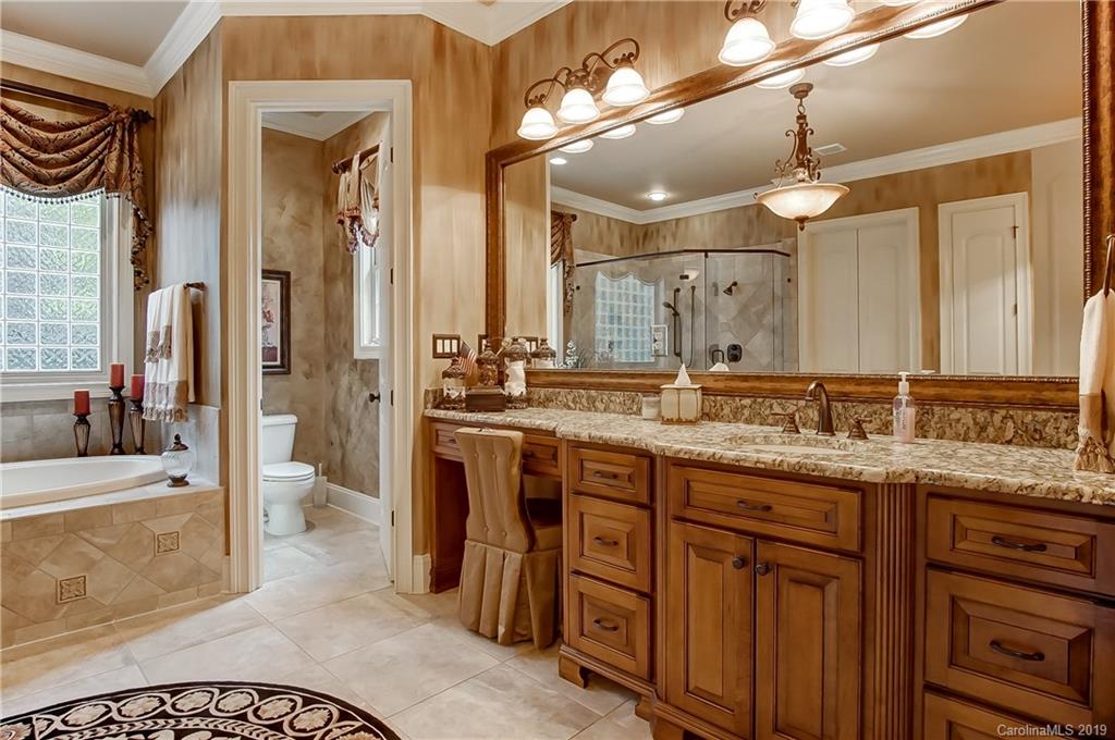 556 Medora Lane Fort Mill, SC 29708 - Photo 16 of 47 a spacious bathroom with a granite countertop sink a mirror and a shower