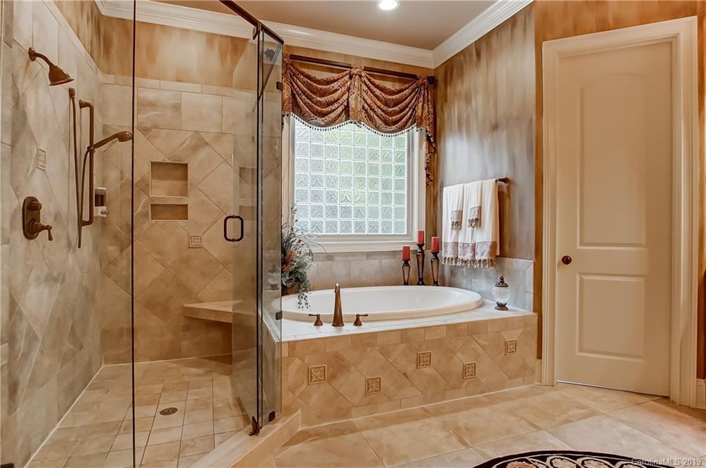556 Medora Lane Fort Mill, SC 29708 - Photo 17 of 47 a bathroom with a bathtub and a shower