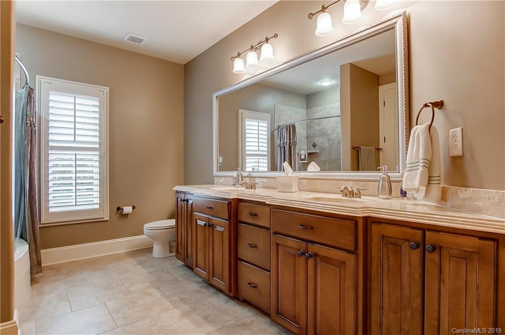 556 Medora Lane Fort Mill, SC 29708 - Photo 20 of 47 a spacious bathroom with a double vanity sink a toilet and a mirror