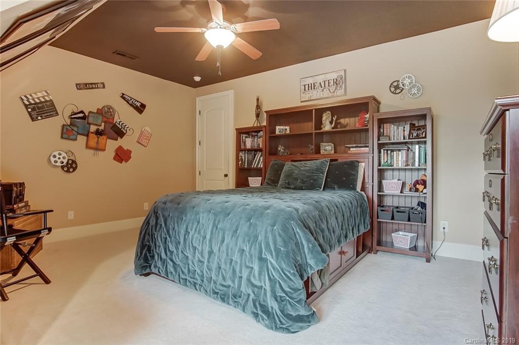 556 Medora Lane Fort Mill, SC 29708 - Photo 21 of 47 a bedroom with a large bed and a chandelier