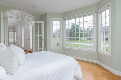 a bedroom with a large bed and a large window