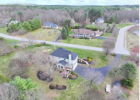 an aerial view of a house with a yard basket ball court