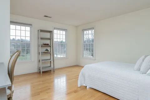 a bedroom with a bed furniture and a window