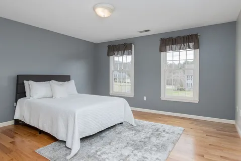 a bedroom with a bed and window