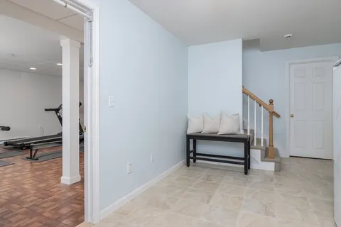 a room with gym equipment and a wooden floor