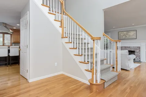 a view of entryway with wooden floor and stairs