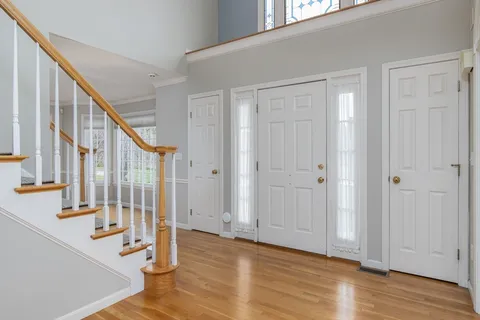 a view of an entryway with wooden floor and door