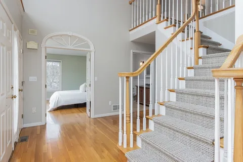 a view of entryway and hall with wooden floor