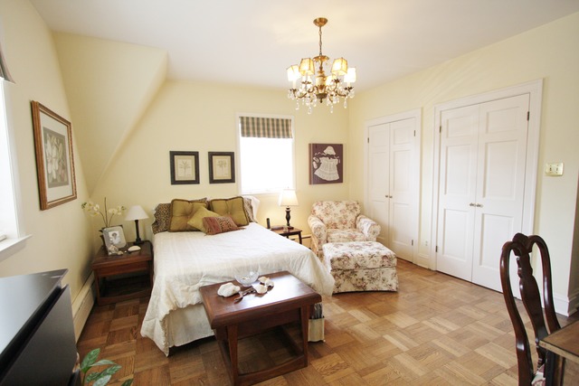 6350 North Indian Road Chicago, IL 60646 - Photo 12 of 23 a bedroom with a bed chandelier and a window