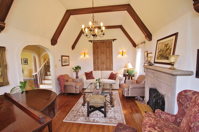 6350 North Indian Road Chicago, IL 60646 - Photo 3 of 23 a living room with furniture a fireplace and a chandelier