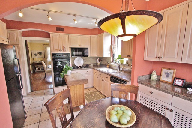 6350 North Indian Road Chicago, IL 60646 - Photo 6 of 23 a kitchen with stainless steel appliances granite countertop a sink a stove and a refrigerator