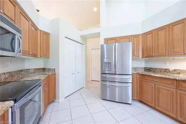 a kitchen with stainless steel appliances granite countertop a refrigerator sink and cabinets
