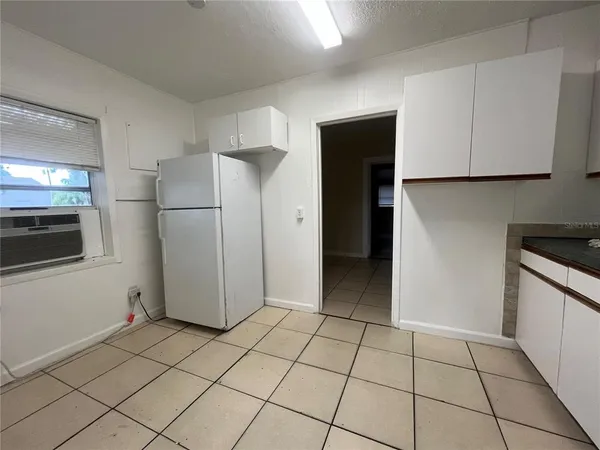 a view of a kitchen with a sink and a refrigerator