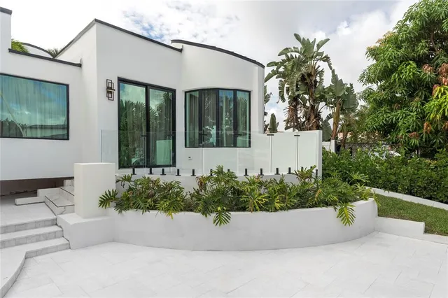 a living room with fireplace furniture and a large window