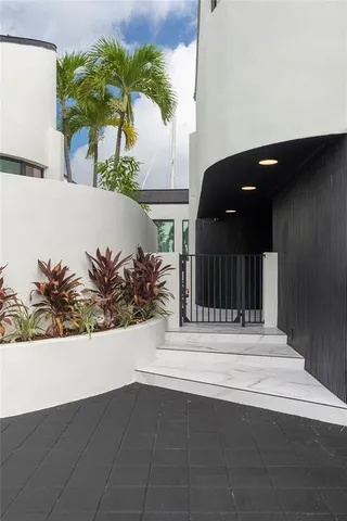a living room with furniture potted plant and a large window