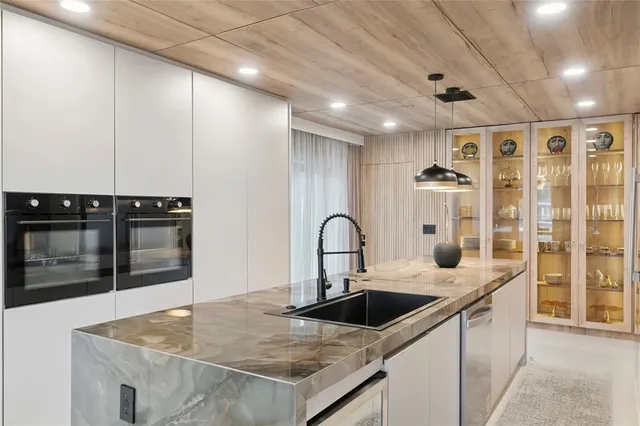 a view of a room that has a window and a table in it