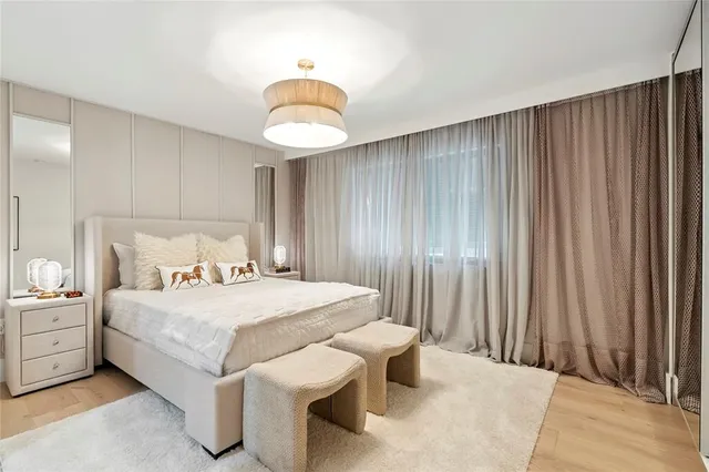 a large bedroom with a bed and a chandelier