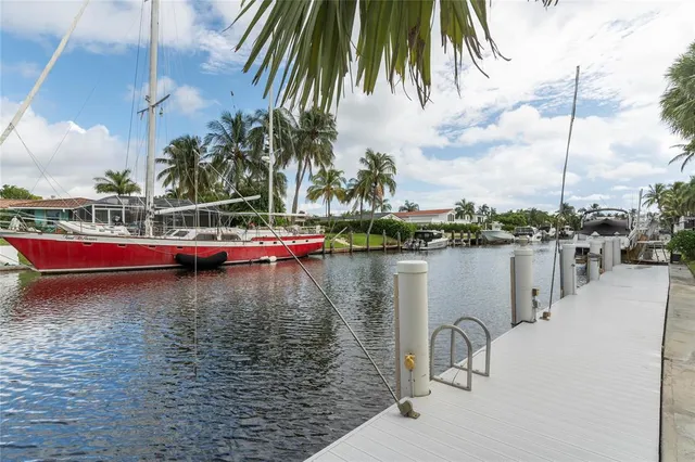 a view of a patio with couches and table with swimming pool