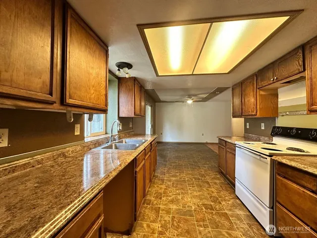 a kitchen with stainless steel appliances granite countertop a sink and cabinets
