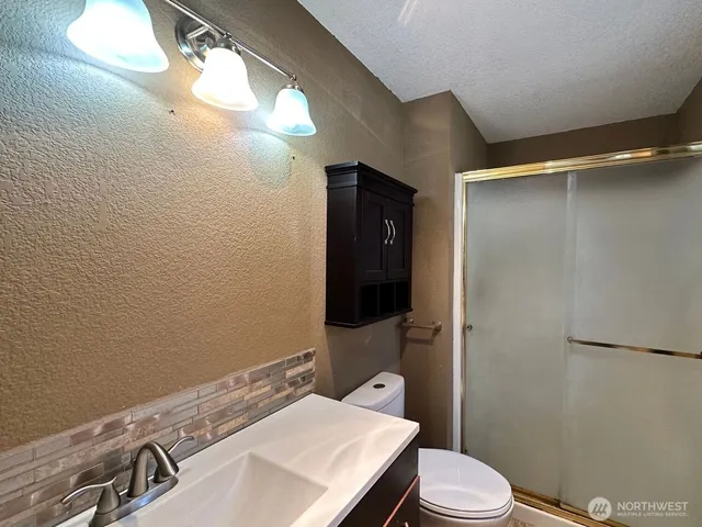 a bathroom with a sink vanity and a mirror