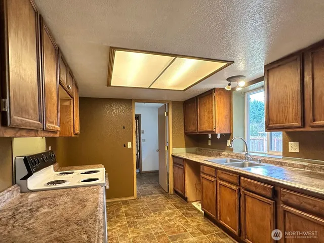 a kitchen with a sink and a refrigerator