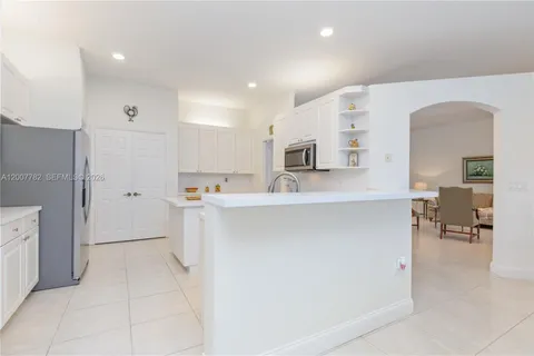 a kitchen with stainless steel appliances a refrigerator sink and cabinets