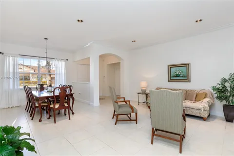 a view of a dining room with furniture and chandelier