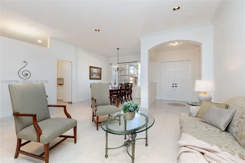 a living room with furniture and a mirror