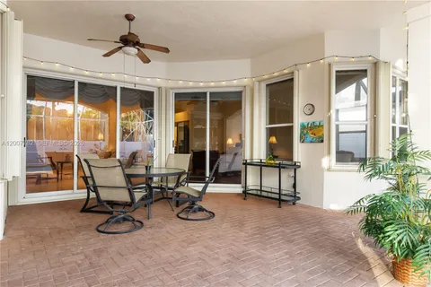 a view of a patio with table and chairs