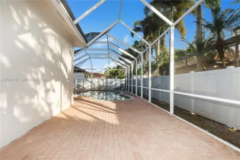 a view of a white building with a swimming pool