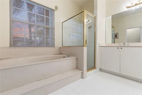 a bedroom with two beds and wooden floor