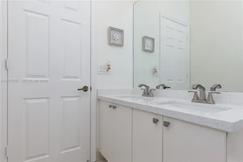 a bedroom with two beds and a desk