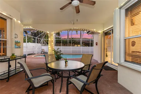a swimming pool with patio outdoor seating and yard
