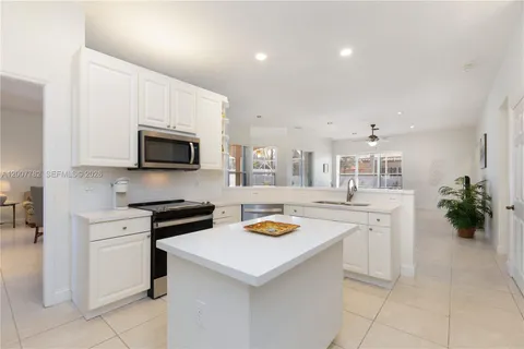 a kitchen with a stove a sink and a microwave